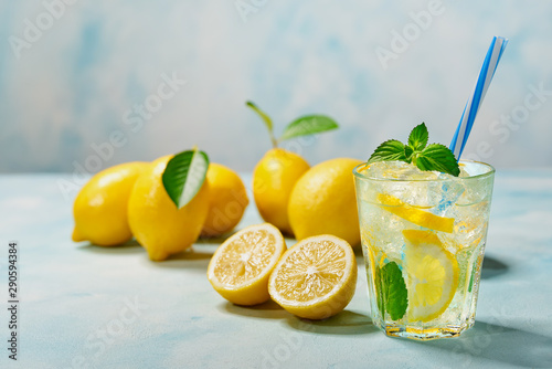 Freshly made lemonade  on a light background, cold refreshing drink .