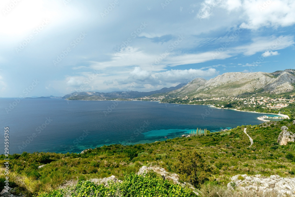 Views of the Adriatic Sea - clear blue water, boat, rocky shore. Sea cruise in a paradise