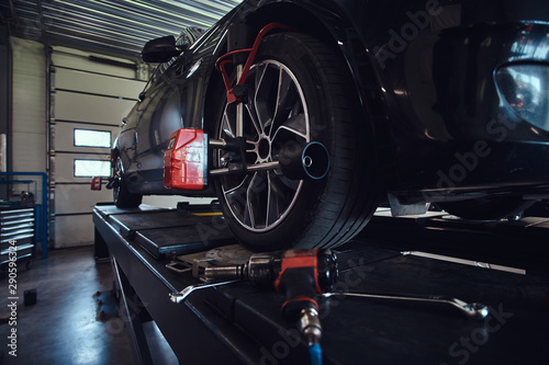 Closeup photo shoot of process or tyre balancing at dark auto service.
