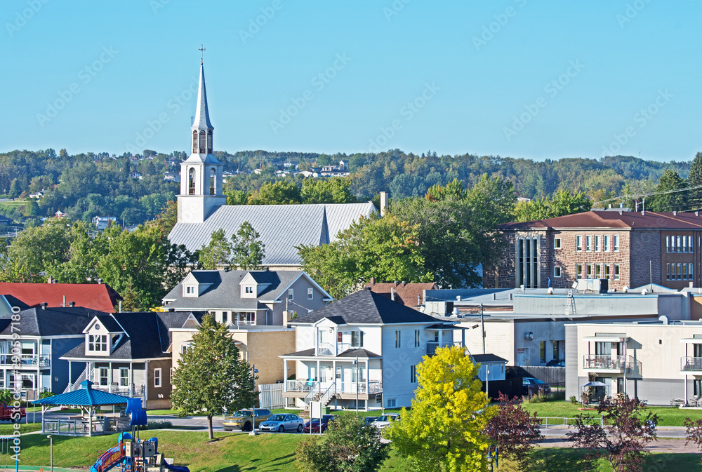 Fototapeta premium A view of Saguenay with the church of Saint Alphonse of Liguori dominating the skyline.