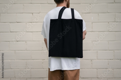 Man holding cotton Black Tote bag photo