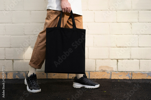 Man holding cotton Black Tote bag