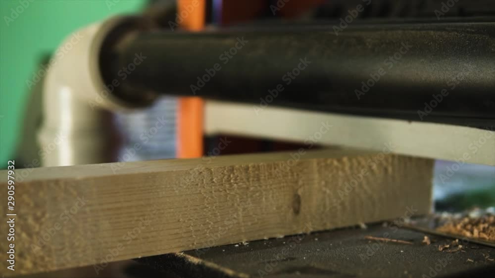Worker polishing wooden boards with abrasive machine Worker polishing wooden boards with abrasive machine