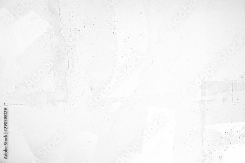 Neutral blank low contrast white textured background with roughness and irregularities to your concept or product. White plaster painted on concrete stone wall. photo