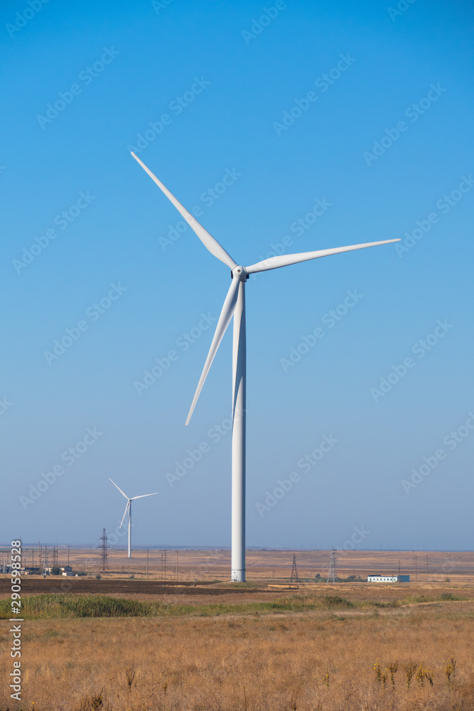 Propellers of windmills, close-up. Spinning wind turbines on blue sky background, close up Propellers of windmills, close-up. Spinning wind turbines on blue sky background, close up