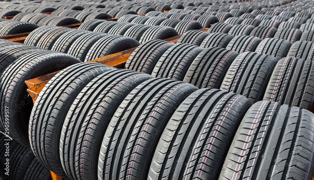 New tires for sale at a tire store. Car tires in the warehouse under the open sky