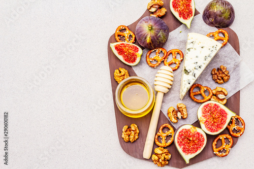 Cheese platter  board  with blue cheese  honey  walnuts  figs  pretzels