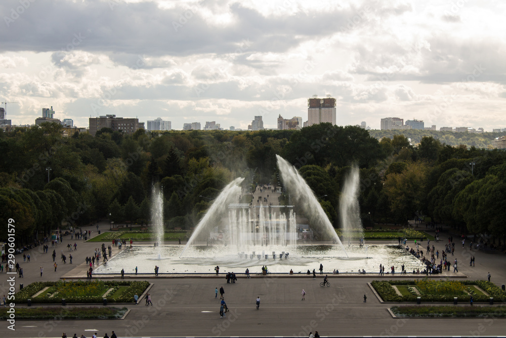 Fototapeta premium Panoramic view of the Gorky Park with a fountain and flowerbeds cloud on a summer day