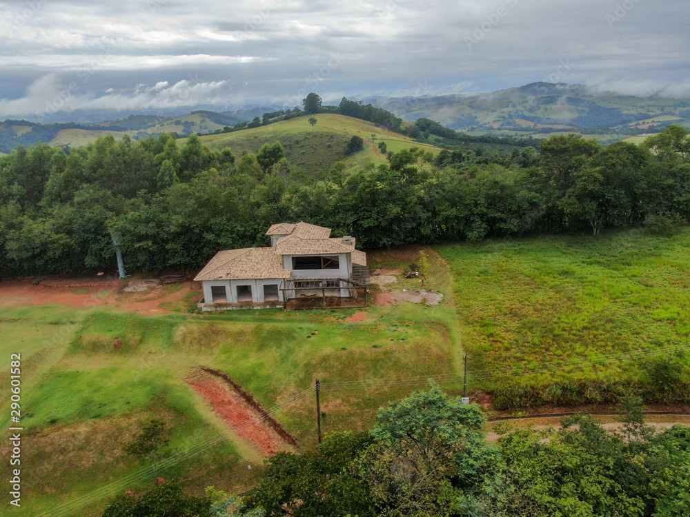 Aerial view of villa under construction in green valley