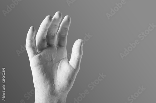 elegant white plaster hand on a gray background