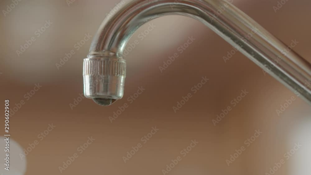 Slow motion shot of water flowing out of a tap, shot at 150 frames per second Slow motion shot of water flowing out of a tap, shot at 150 frames per second