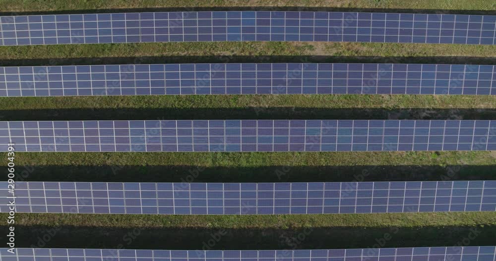 Solar panel farm Aerial view 4K. Alternative Renewable sun energy power plant.
