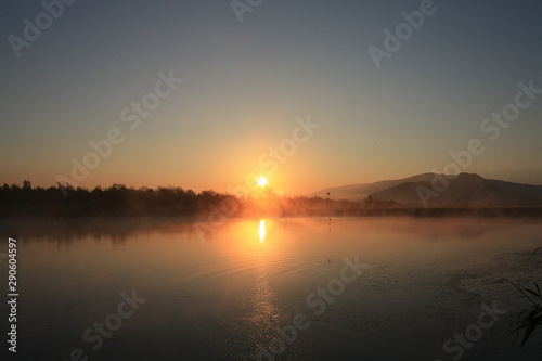 sunrise with fog on the lake