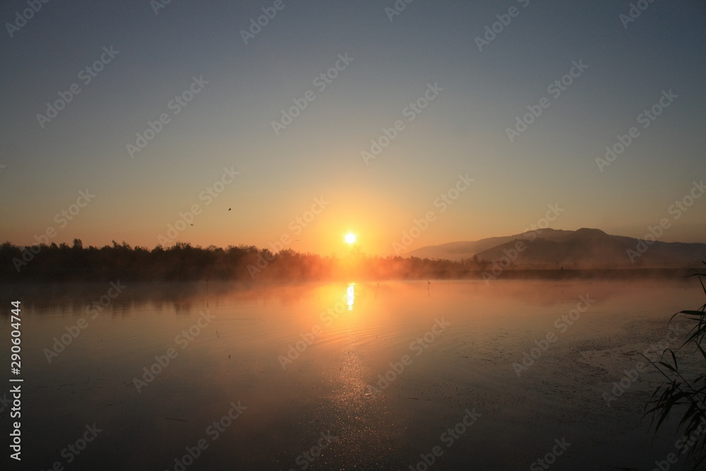 sunrise with fog on the lake
