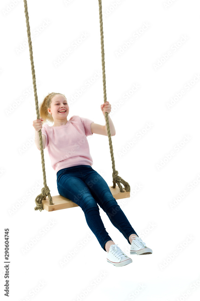 Beautiful teen school girl swinging on a swing. Concept summer v Beautiful teen school girl swinging on a swing. Concept summer v