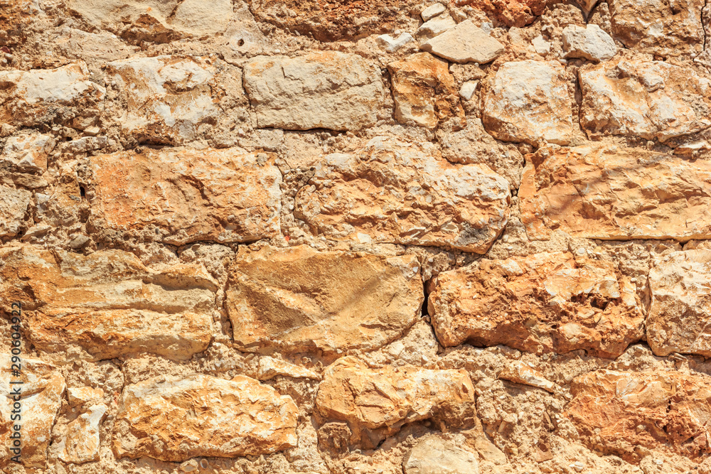 Fototapeta premium Old weathered brick medieval wall, horizontal grunge background, in Hvar old town quarter, in Croatia