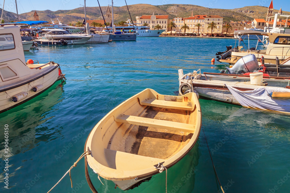 Coastal summer landscape - view of the marina for boats and of the Old Town of Trogir, the Adriatic coast of Croatia