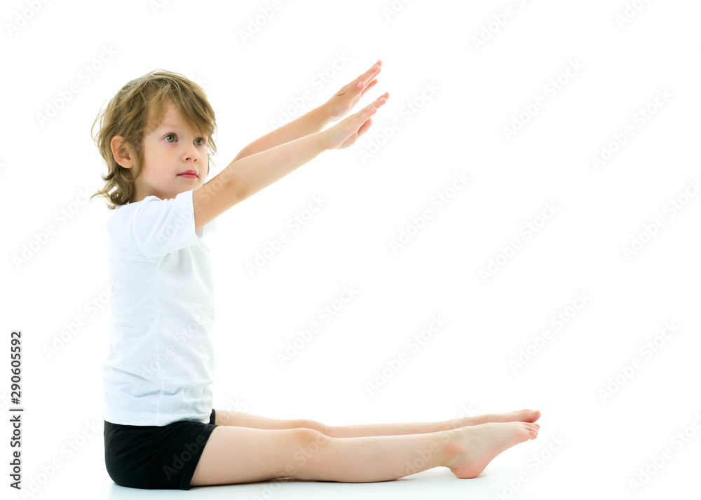 Charming little girl doing gymnastic exercises in the studio on Charming little girl doing gymnastic exercises in the studio on