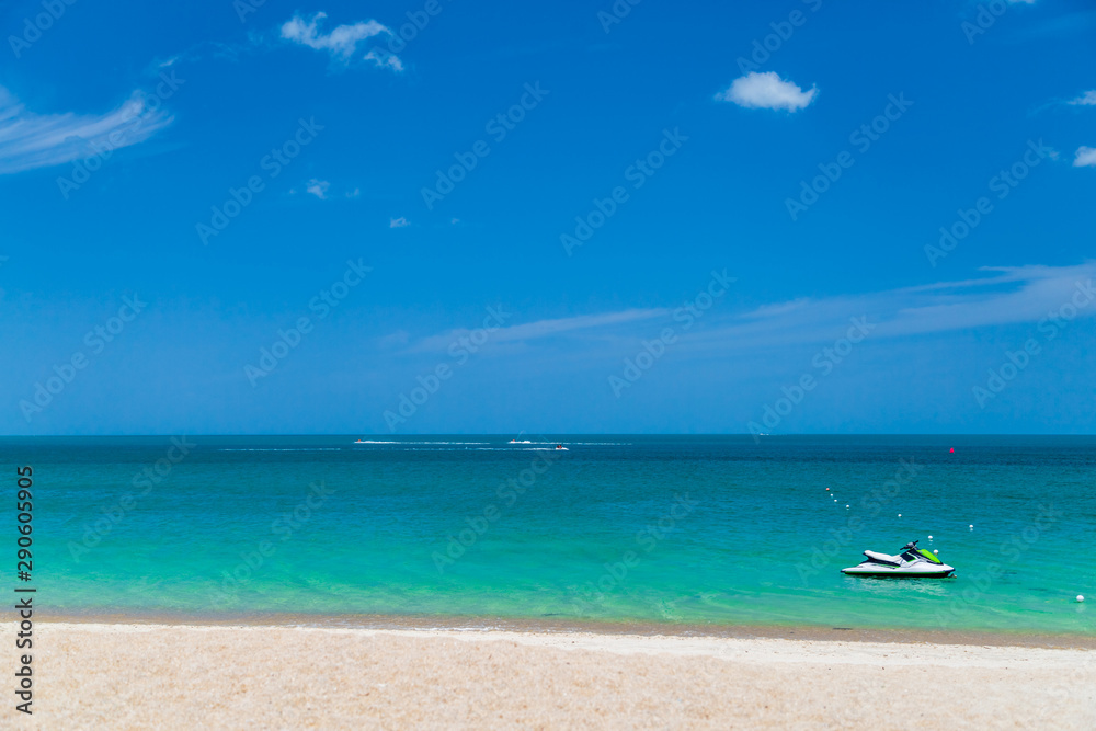 The ocean is turquoise and the boat is far away. Thailand. Samui. Gulf of Thailand. Lamai Beach