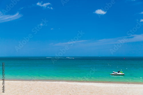 The ocean is turquoise and the boat is far away. Thailand. Samui. Gulf of Thailand. Lamai Beach