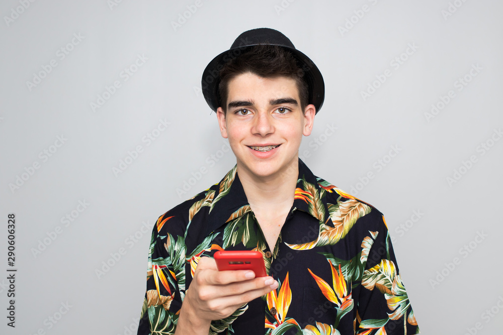 casual style young man with hat and mobile phone on background