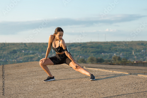 A young slim athletic girl in sportswear with snakeskin prints performs a set of exercises. Fitness and healthy lifestyle.  © Mountains Hunter