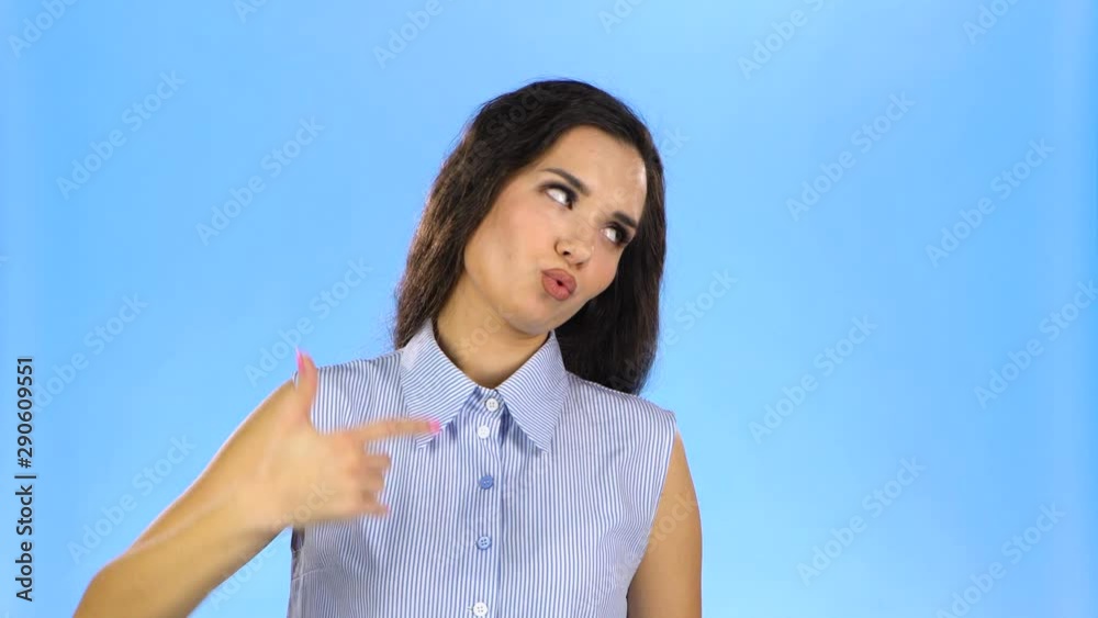 Woman emotionally putting fingers to her temple like gun Woman emotionally putting fingers to her temple like gun