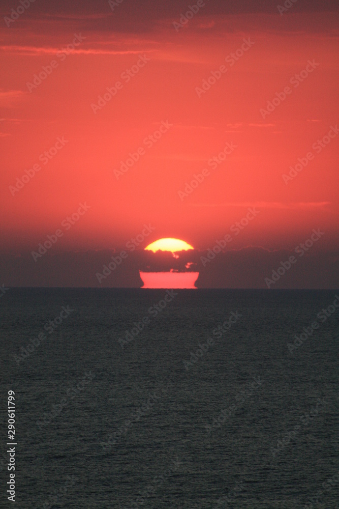 a sunrise among the clouds at the seashore a sunrise among the clouds at the seashore