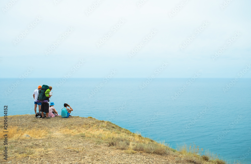 Tourism Relaxing On hill And Looking At Sea In Summer.