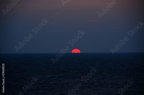the sun rising from the water of the sea © sebi_2569
