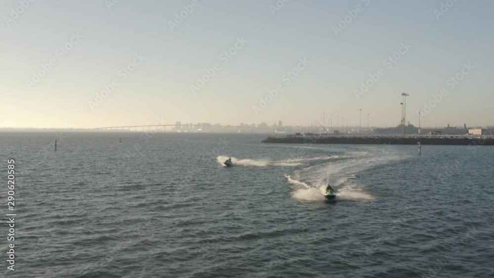 Aerial Shot, Jet Ski Riders During Golden Hour In The Bay San Diego. Dolly In. Aerial Shot, Jet Ski Riders During Golden Hour In The Bay San Diego. Dolly In.