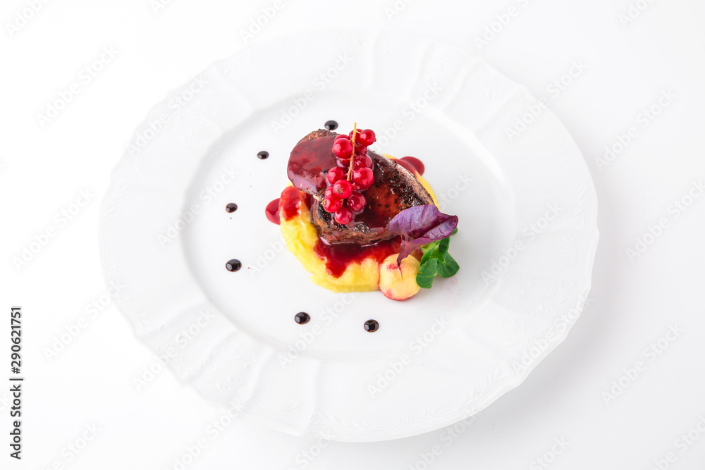 Foie gras with beef minion, mashed asparagus and  artichoke, with berry sauce. Banquet festive dishes. Fine dining restaurant menu. White background.