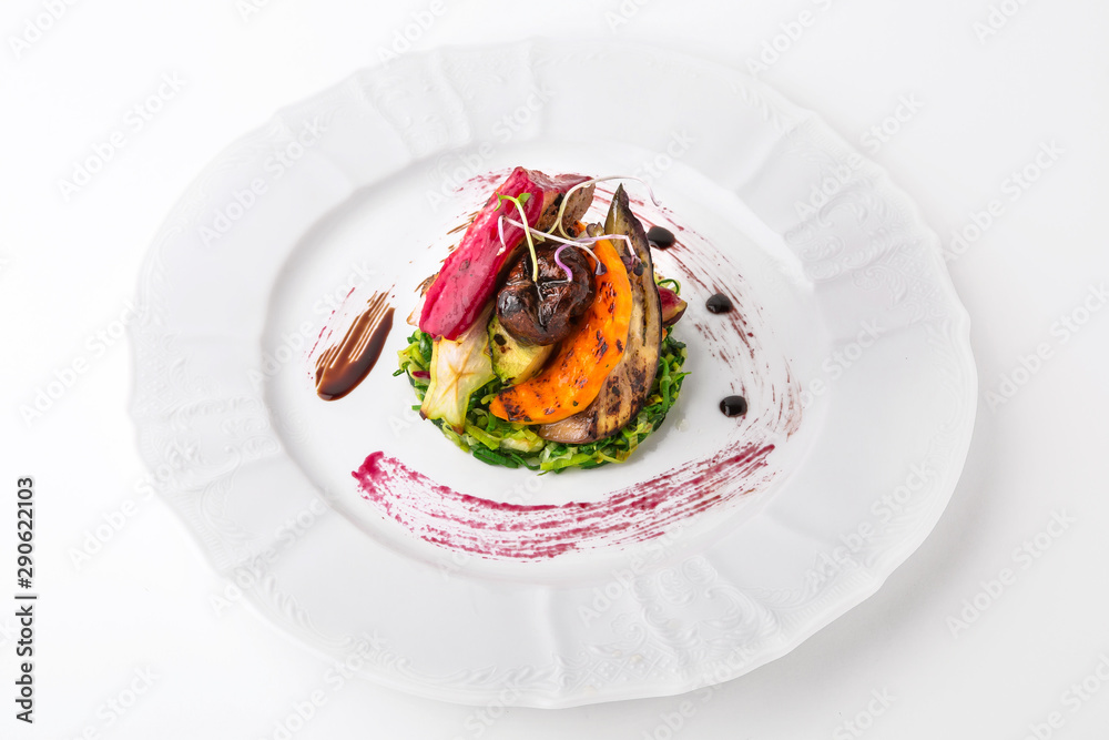 Tender grilled pork meat, vegetables and berry sauce. Banquet festive dishes. Gourmet restaurant menu. White background.