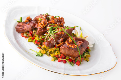 Meat roast with vegetables, nuts in sauce. Rabbit, lamb, or duck baked in the oven. Banquet festive dishes. Gourmet restaurant menu. White background.