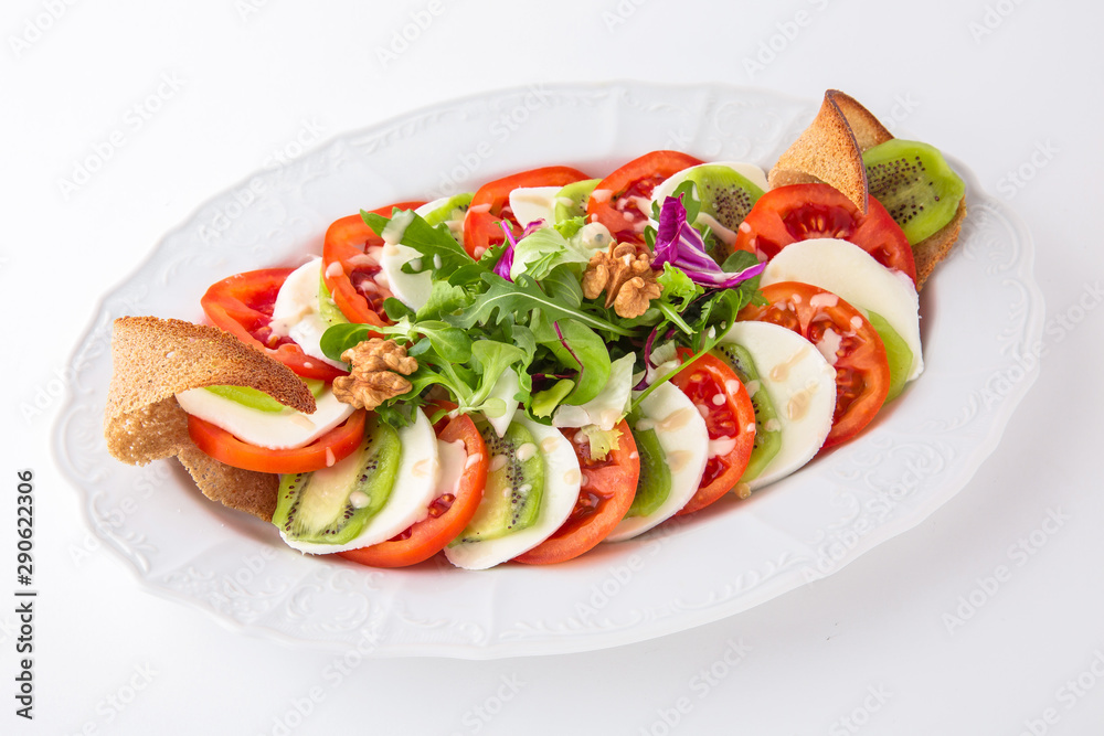 Snack made from fresh vegetables: tomatoes, mozza. Banquet festive dishes. Gourmet restaurant menu. White background. Snack made from fresh vegetables: tomatoes, mozza. Banquet festive dishes. Gourmet restaurant menu. White background.