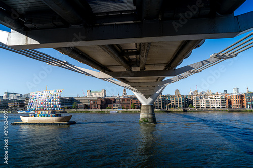 London Uk September 8th 2019 London River Thames from the south bank showing Tate art viking long boat model with multicoloured peace sail on barge by Millennium bridge with St Pauls opposite © Pluto119