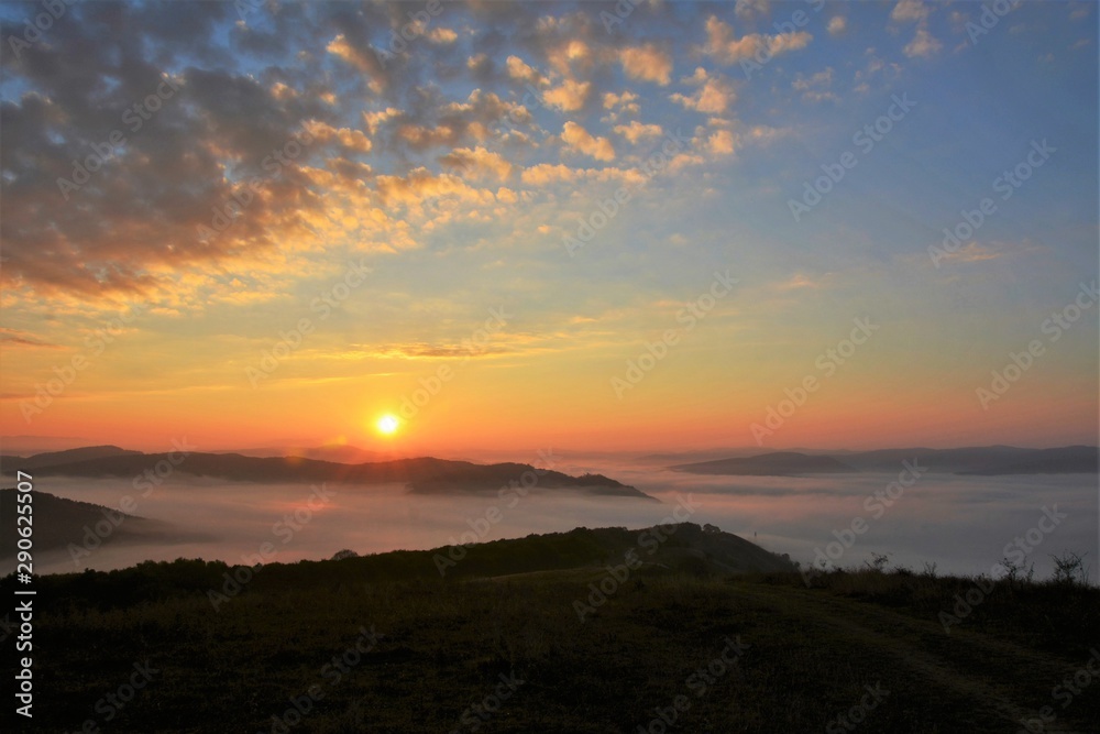 sunrise over the mountains with fog in the valley