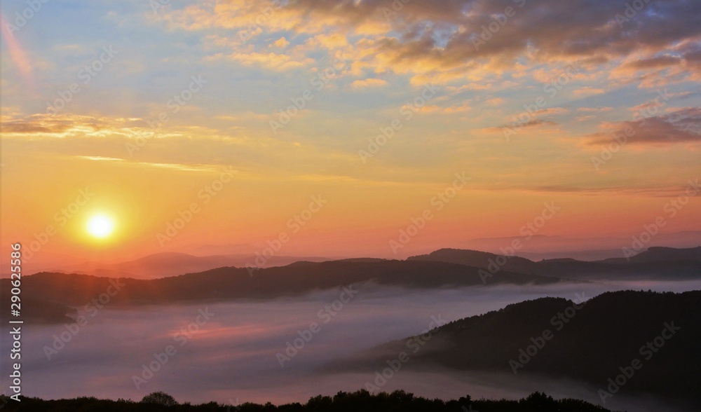sunrise over mountains with fog in the valley