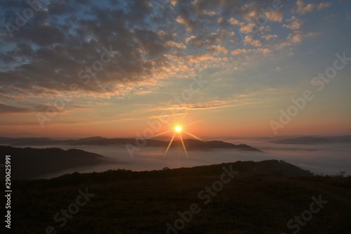 sunrise over the mountains with fog in the valley