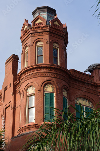 Vertical: Historic Queen Anne style red brick house on Galveston Island, Texas.