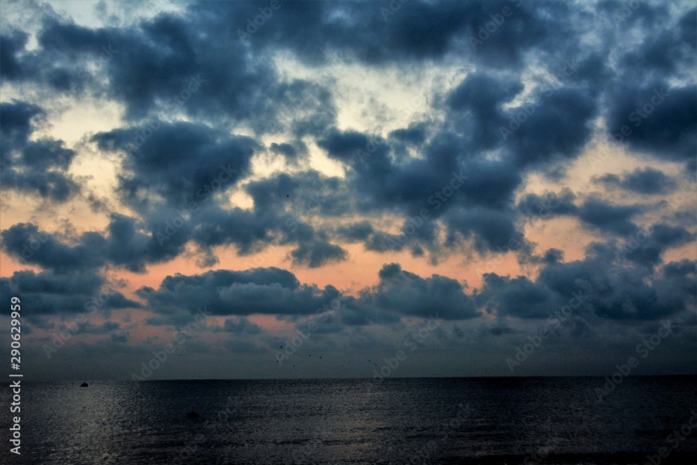 sunrise with clouds in many shades of the sea