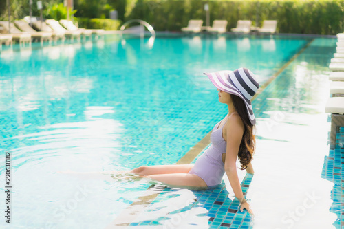 Portrait beautiful asian women happy smile relax around swimming pool in hotel resort