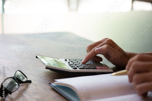 Hand businessman using calculator for calculate tax in office.concept