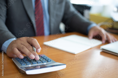businessman hand using calculator for calculate tax in office.concept