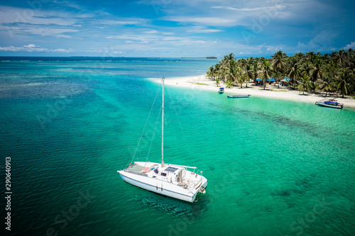 Sail boats docked by beautiful islands