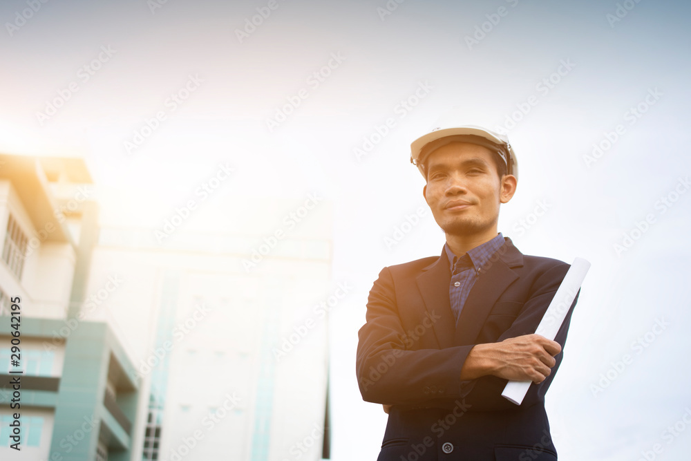 Engineer holding paper plan building sky background Engineer holding paper plan building sky background