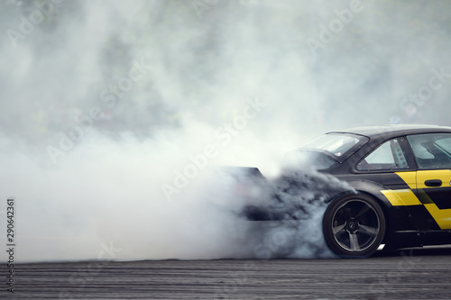 Motion blur close up drift car with  smoke from burning tires © Sorawit