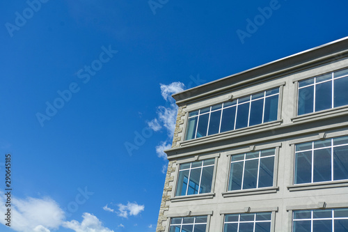 Fragment of the office building by modern architecture on blue sky background