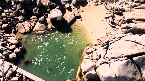 drone view of pool green water near maidens cove ,camps bay , cape town