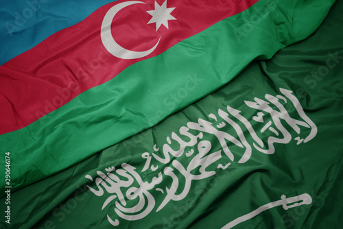 waving colorful flag of saudi arabia and national flag of azerbaijan.